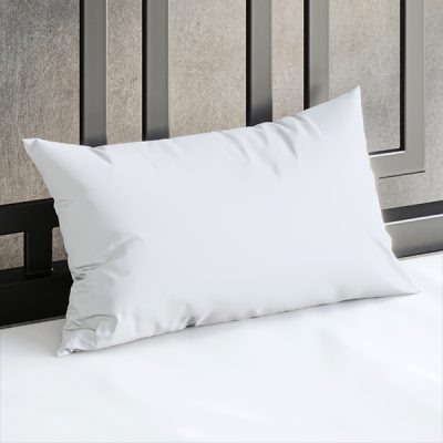 Close up of a Sheets of San Francisco White waterproof pillow case on a bed covered in a White Sheets of San Francisco fluid proof fitted sheet and against a black metal bedhead with the polished concrete wall behind showing through.