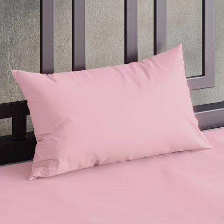 Close up of a Sheets of San Francisco Pink waterproof pillow case on a bed covered in a White Sheets of San Francisco fluidproof fitted sheet and against a black metal bedhead with the polished concrete wall behind showing through.