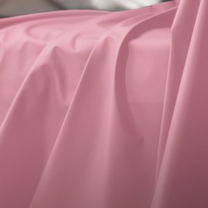 Pink Sheets of San Francisco Fluidproof and Lube proof Throw, showing close up drapes and folds in the fabric