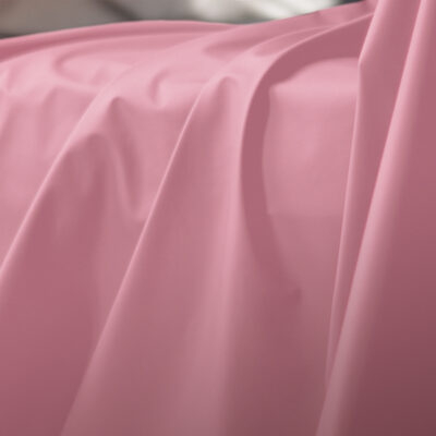 Pink Sheets of San Francisco Fluidproof and Lube proof Throw, showing close up drapes and folds in the fabric