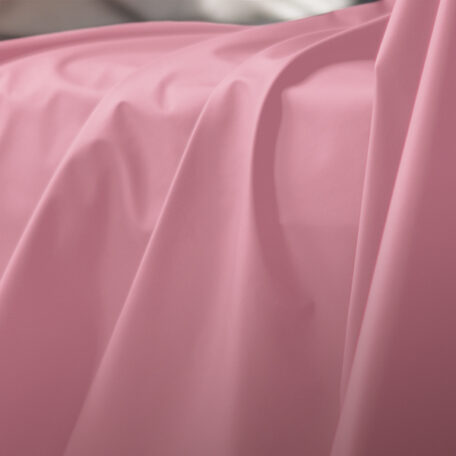 Pink Sheets of San Francisco Fluidproof and Lube proof Throw, showing close up drapes and folds in the fabric